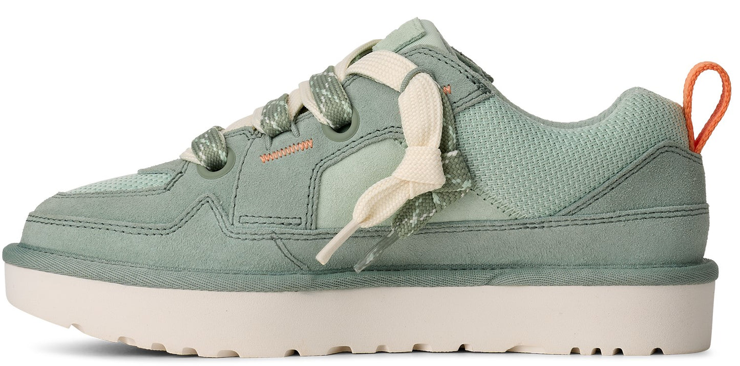 A light green sneaker with thick light beige laces and a beige sole.
