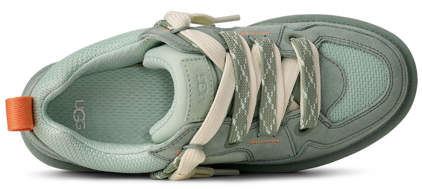 A green sneaker with cream colored laces and an orange pull tab.
