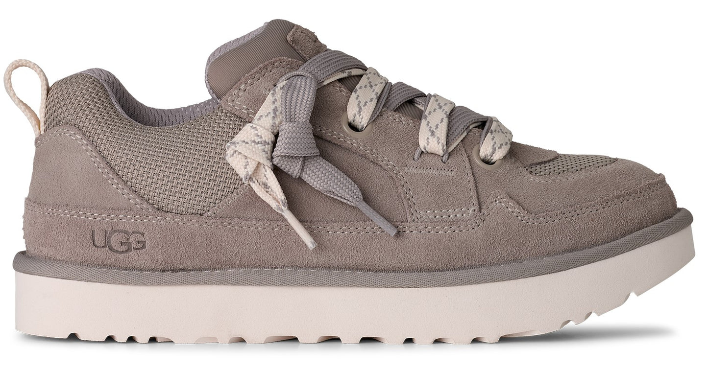 Gray suede and mesh sneaker with a white sole and white patterned laces; UGG logo on side.