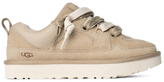 Low-top tan suede sneaker with thick white sole and exaggerated laces.