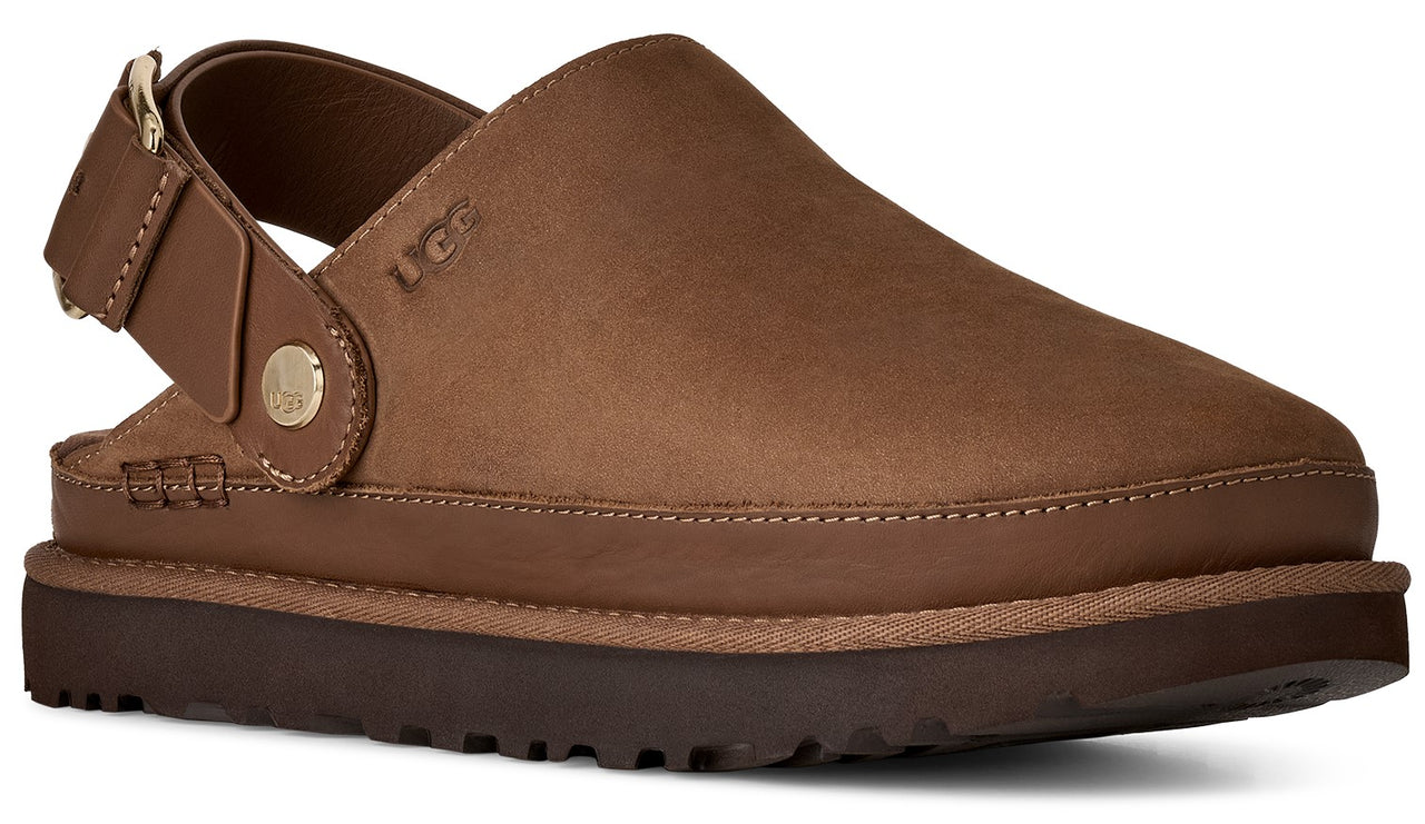 A brown leather UGG branded slide shoe with a thick platform sole and an adjustable ankle strap with a gold-tone metallic stud detail.