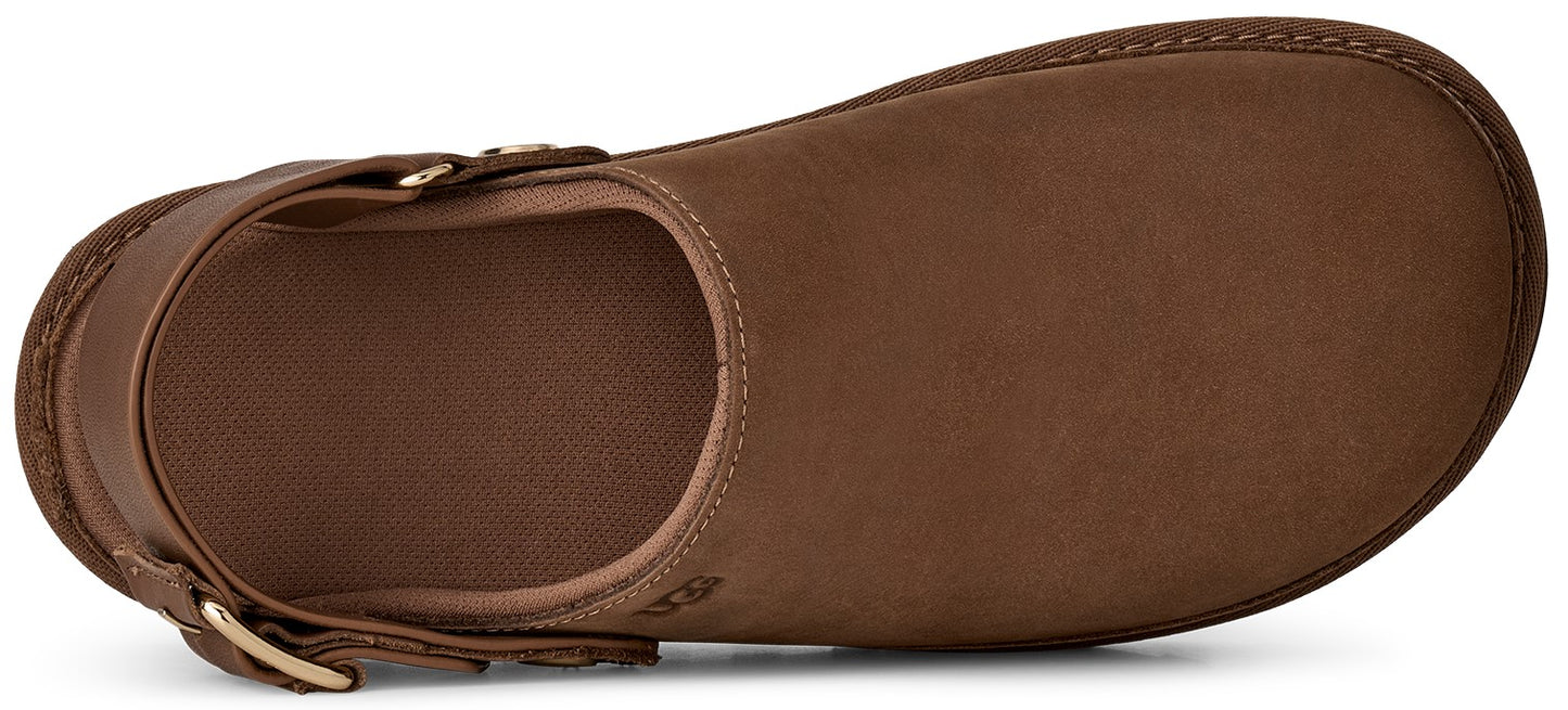A brown leather clog shoe viewed from above, featuring a rounded toe and a heel strap with a gold-tone metal buckle.
