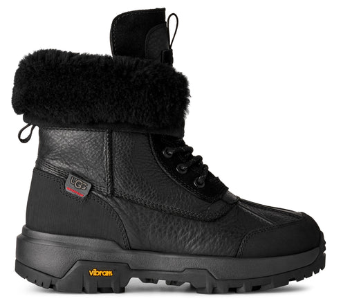 Black duck boot with shearling cuff, leather upper, and lugged sole.