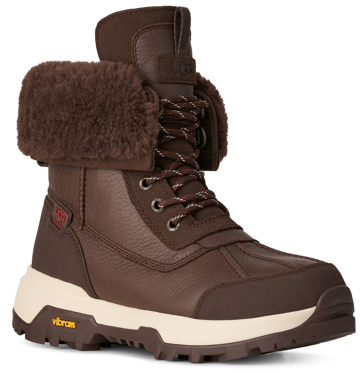 A brown leather UGG lace-up winter boot with a thick fleece cuff, off-white midsole, and yellow Vibram logo on the rugged rubber sole.
