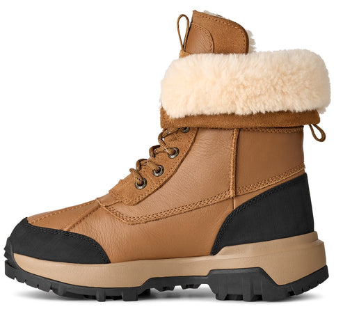 Tan colored boot with black accents and faux fur trim.
