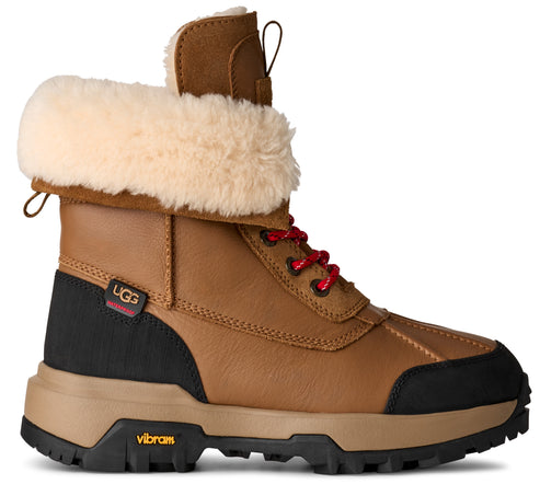 Brown leather boot with black accents, fur lining, and red laces.