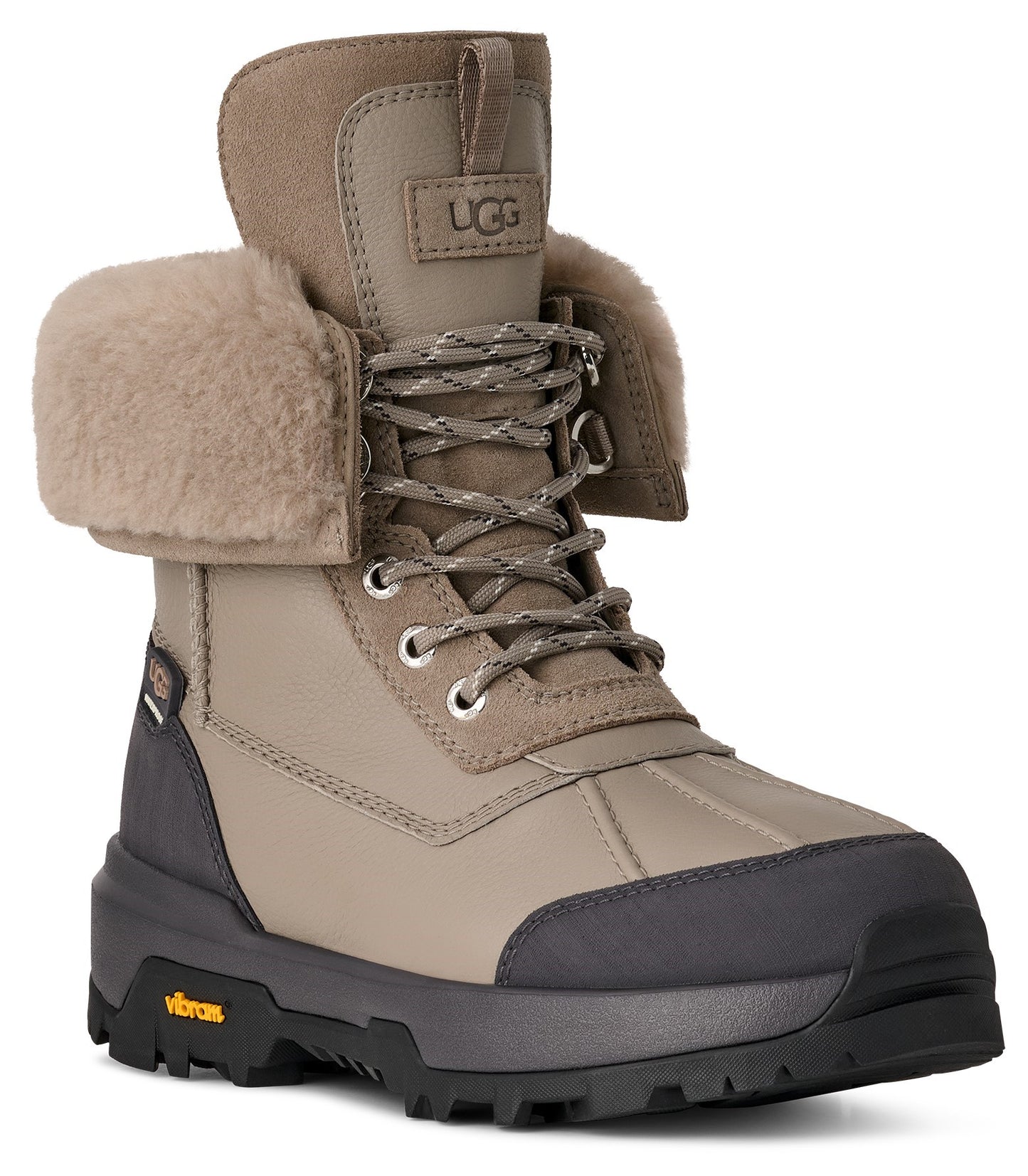 Beige waterproof leather snow boot with sheepskin cuff, lace-up closure, and dark gray Vibram sole.