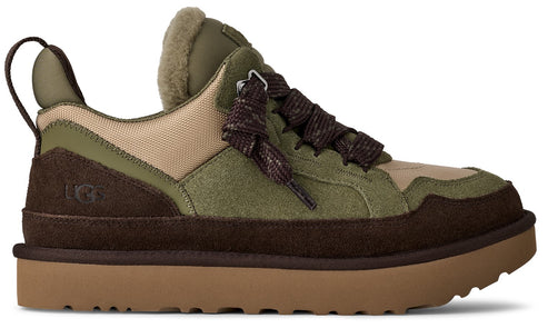 Low-top sneaker with brown sole and heel, brown suede around the heel and along the toe, green suede panels, beige canvas panels, green lining, and brown patterned laces.