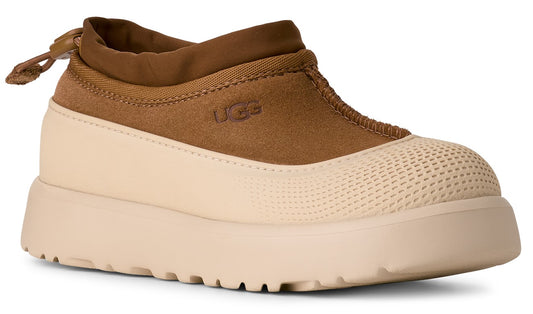 Tan UGG shoe with suede upper, cream rubberized lower and sole.
