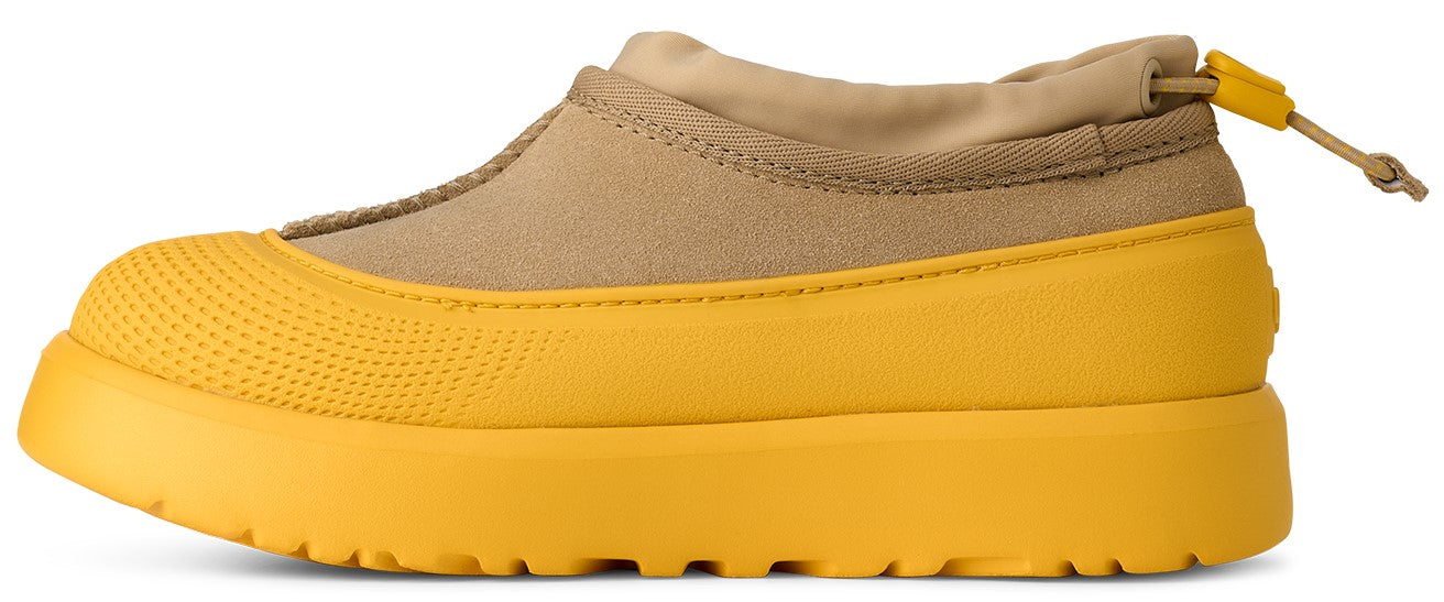 A yellow, low-rise boot with beige canvas, a pull cord, and a thick sole.