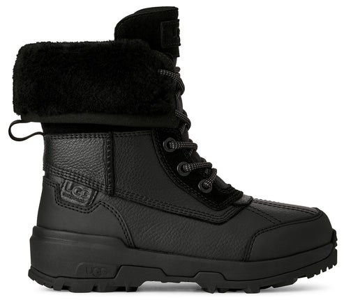 A black leather winter boot with a lace-up front, a thick faux fur cuff at the collar, and a rugged, waterproof sole, featuring an UGG logo stamped on the side heel and embossed on the rubber sole.
