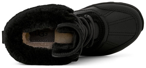 A top-down view of a black, lace-up winter boot with a thick, plush black faux-fur collar and a light-colored shearling-lined interior featuring the UGG logo on the footbed.
