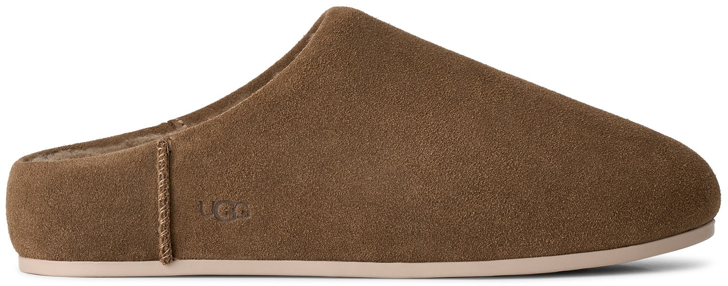 A brown suede slip-on slipper with a low-profile sole and the logo UGG embossed on the side.