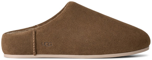 A brown suede slip-on slipper with a low-profile sole and the logo UGG embossed on the side.