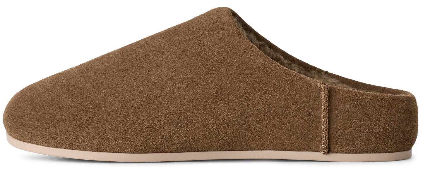A brown suede mule slipper with a flat, light-colored sole and a fuzzy brown interior lining.