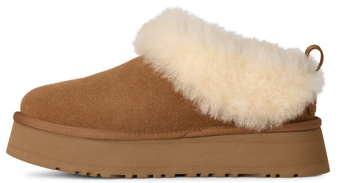 Brown slipper with a platform sole and cream-colored sheepskin trim.