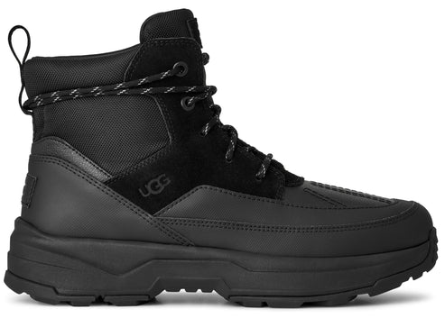 Black high-top boot with suede accents and a thick, treaded sole.