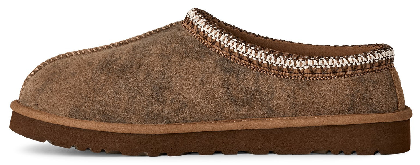 A brown slip-on shoe with a thick sole and a decorative white and brown trim.