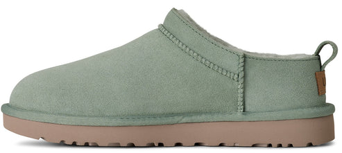 A green UGG Tasman slipper with a light brown sole.