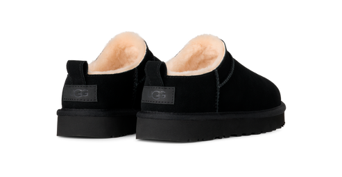 A pair of black suede scuff slippers with shearling linings, and platform soles.