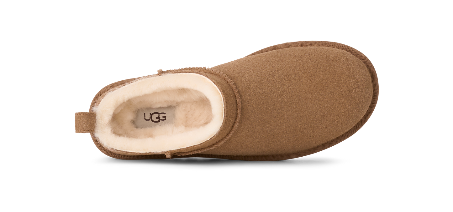 top-down view of a suede clog with a sheepskin lining visible at the opening that shows a printed logo.