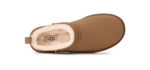 top-down view of a suede clog with a sheepskin lining visible at the opening that shows a printed logo.