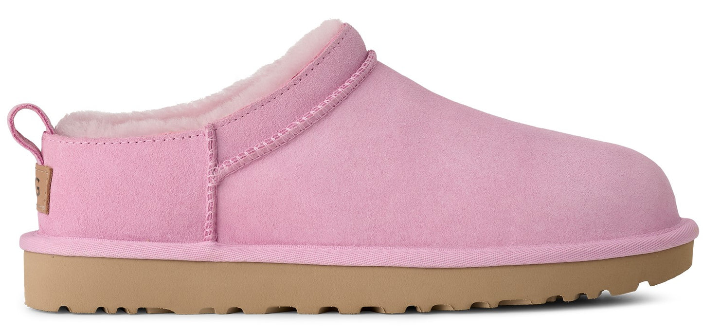 Pink slipper with a brown sole and a sheepskin interior.