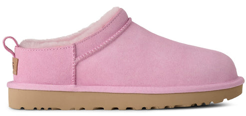 Pink slipper with a brown sole and a sheepskin interior.