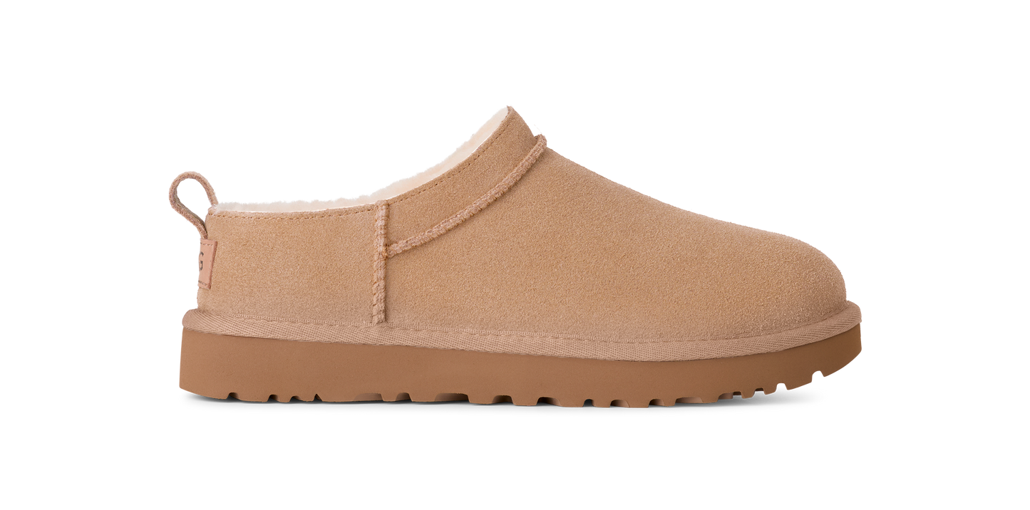 Tan-colored, slip-on style shoe with a low profile and rounded toe.