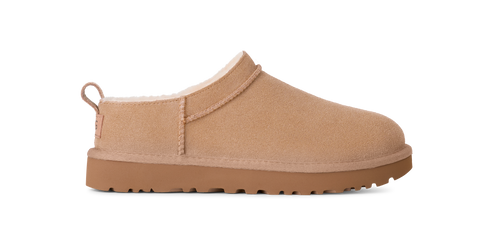 Tan-colored, slip-on style shoe with a low profile and rounded toe.
