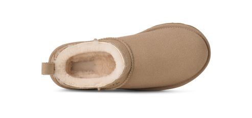 A close-up shot of a beige Ugg boot with white fur.