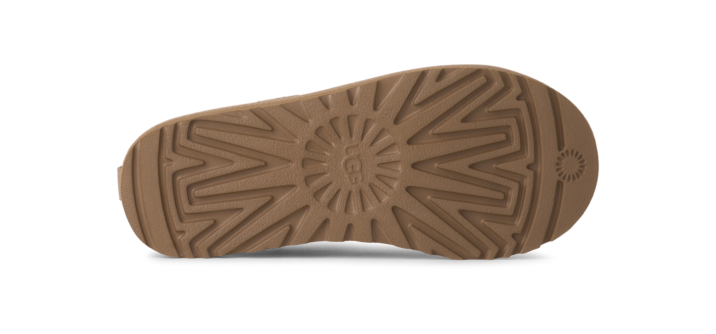 Sole of a tan UGG boot with prominent tread pattern.