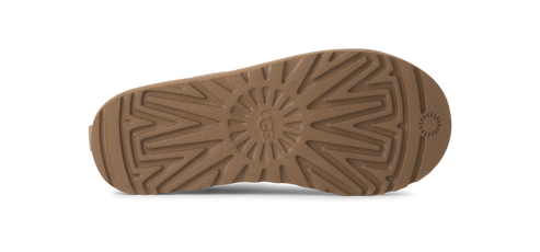 Sole of a tan UGG boot with prominent tread pattern.