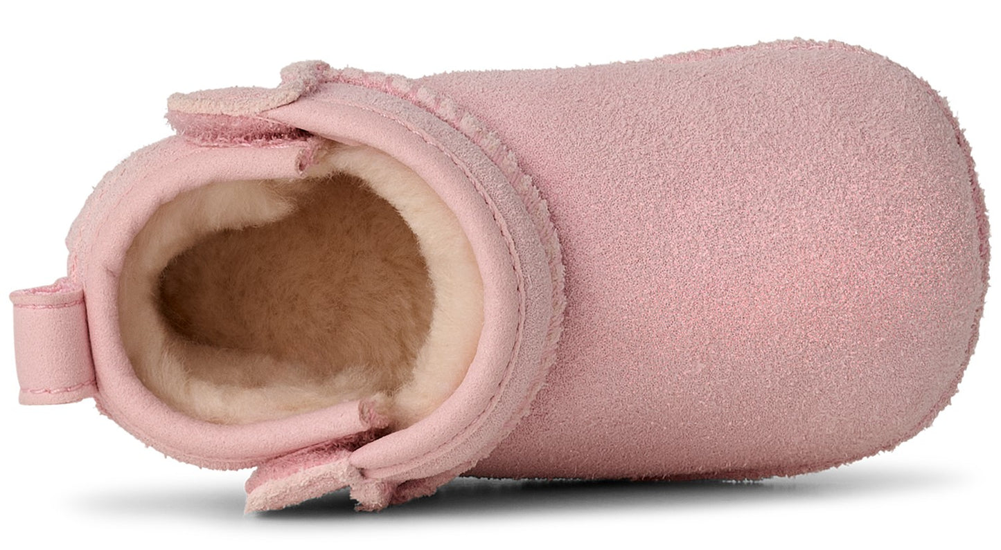 Pink suede baby bootie with exposed white fur lining.