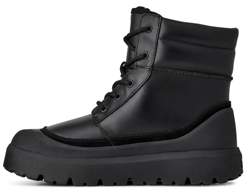 Black lace-up lug sole boot with padded collar.