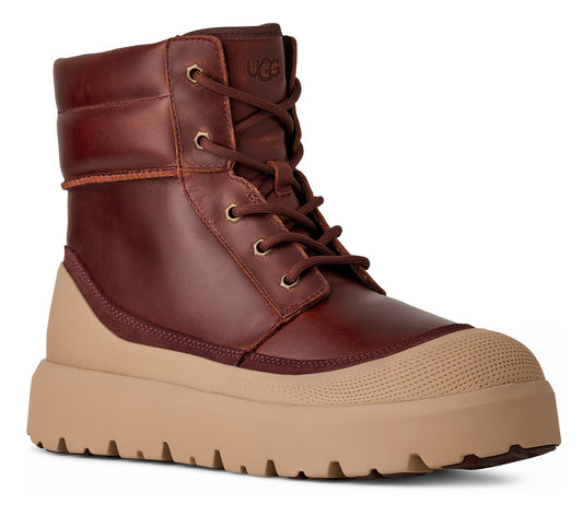 A reddish-brown ankle boot with a beige rubber toe and sole and dark-brown laces.