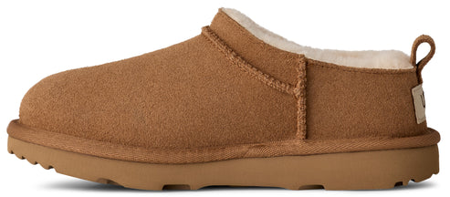 A tan-colored slipper with a round toe and a thick sole, lined with cream-colored fur.