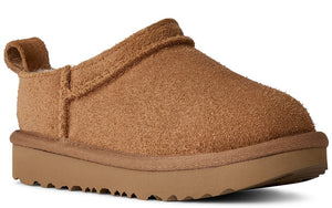 Closed-toe brown slipper with low platform sole and a pull tab on the heel.