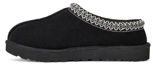 Black slipper with decorative stitching around the opening.