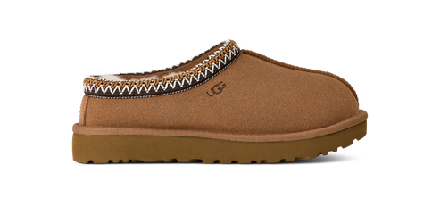 A tan UGG slip-on shoe with decorative trim.