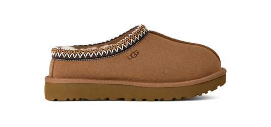 A tan UGG slip-on shoe with decorative trim.