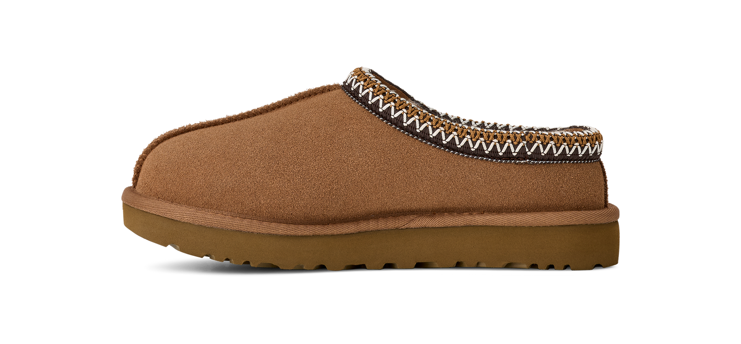A brown suede slipper with a woven trim.