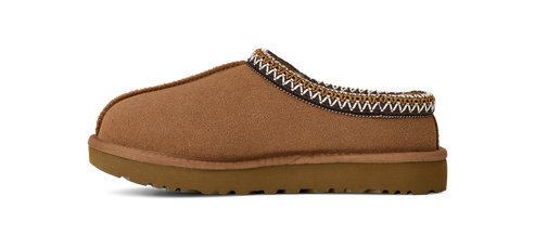 A brown suede slipper with a woven trim.