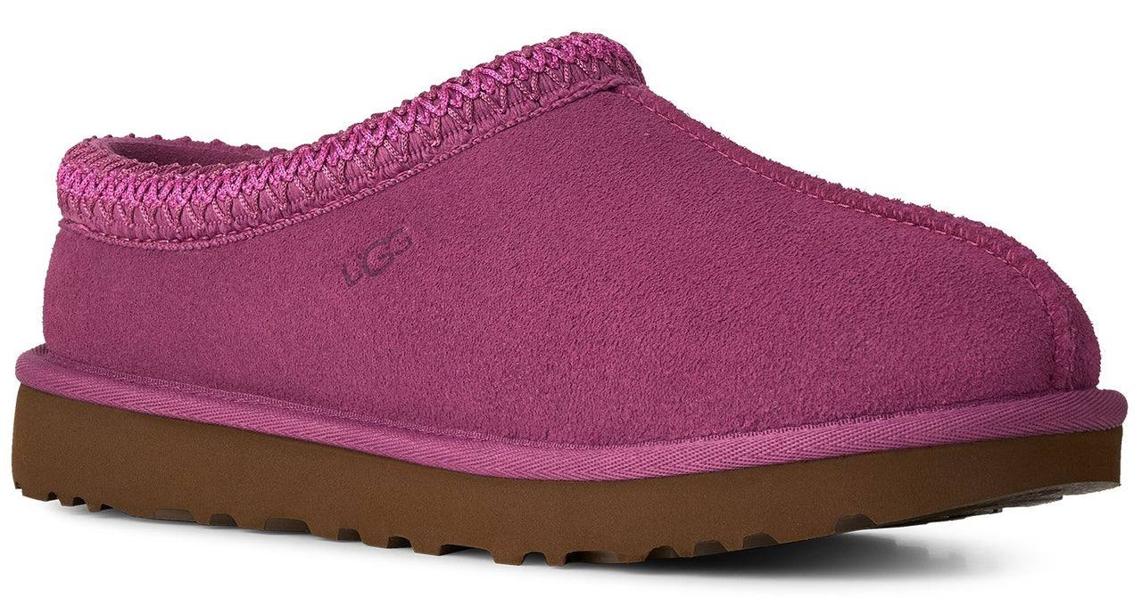 A fuchsia suede slipper with a braided trim around the opening and a brown textured rubber sole.
