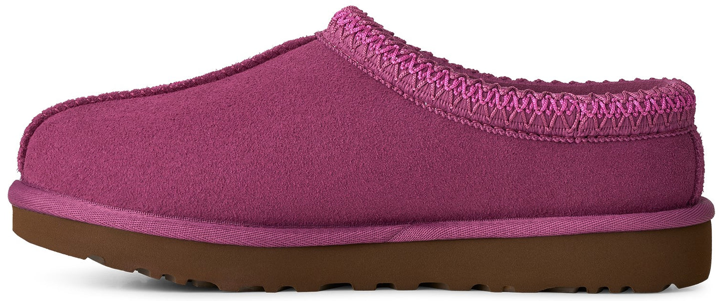 A fuchsia-colored suede slipper with a thick brown rubber sole and a braided trim along the collar.