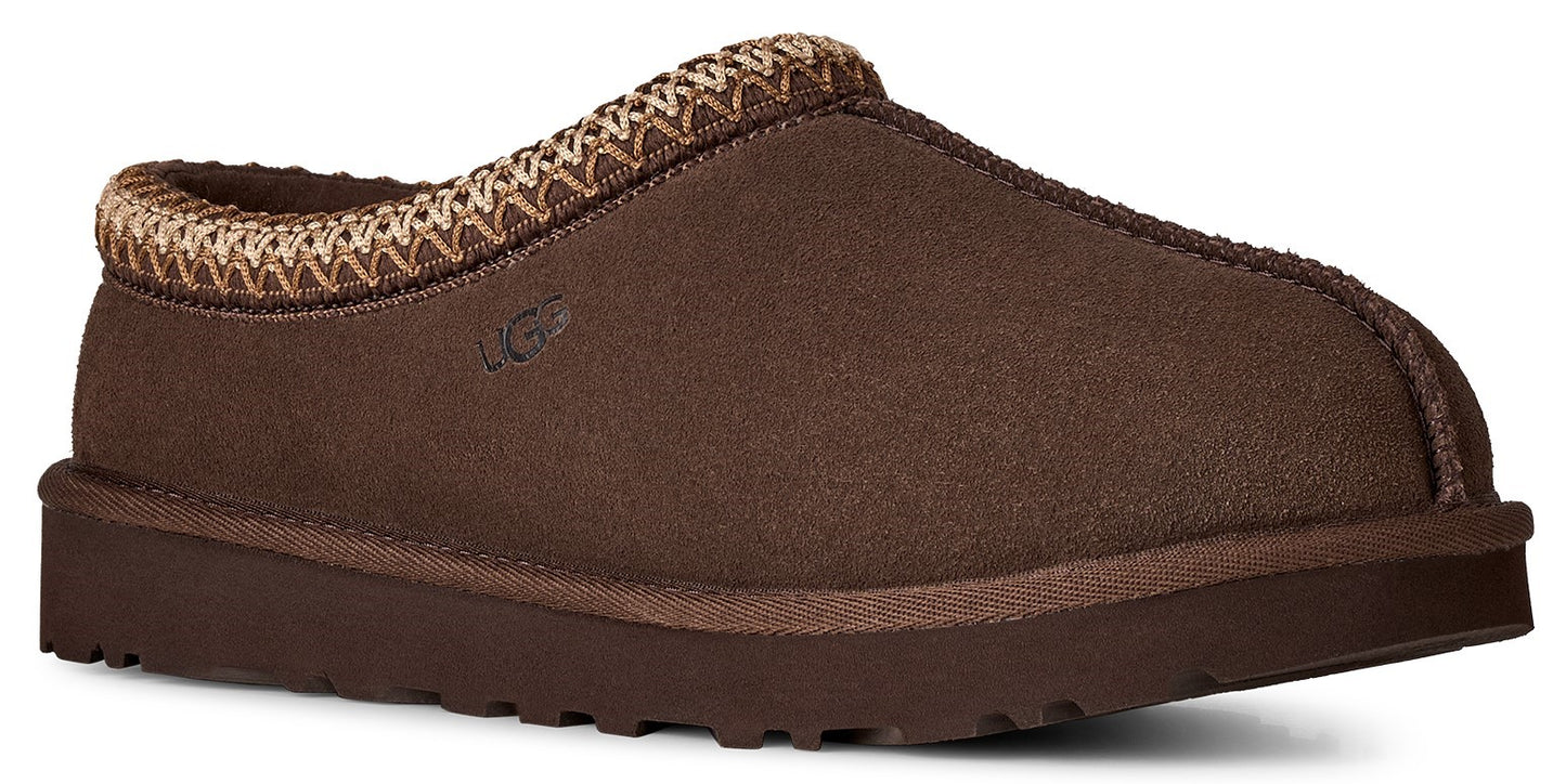 A brown suede slip-on slipper with a platform rubber sole and a decorative braided trim along the collar.