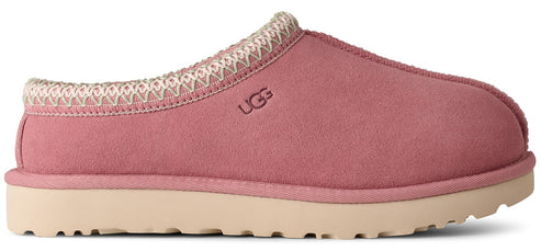 Pink UGG slipper with decorative trim.
