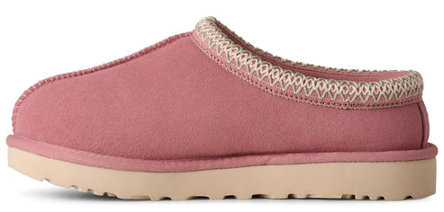 Pink slipper with a beige sole and decorative trim.