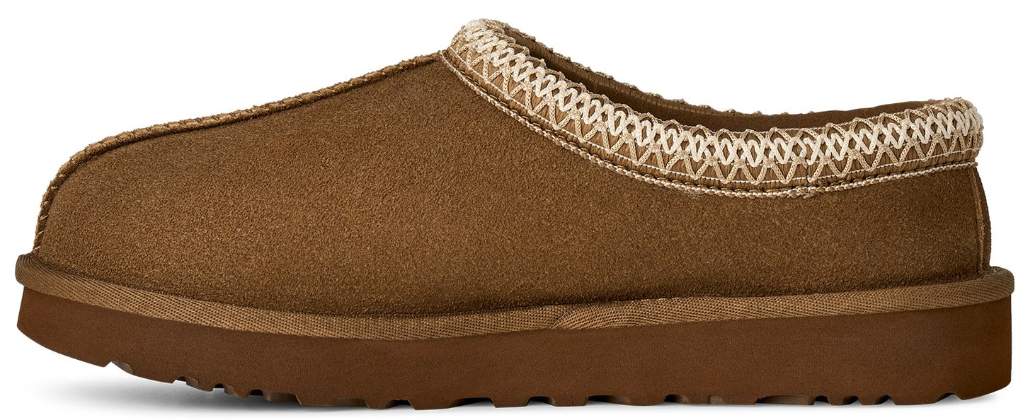 A brown suede slip-on slipper with a thick rubber sole and a decorative woven braid pattern along the collar.