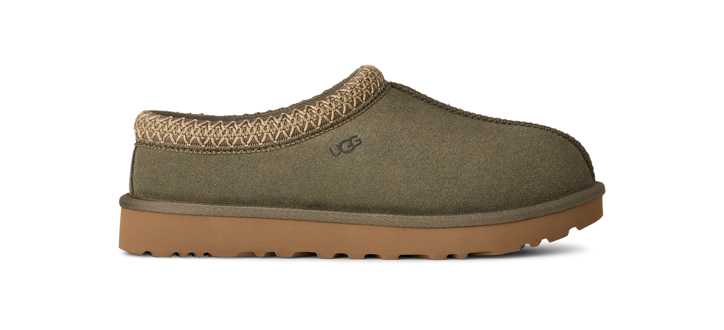 A green slip-on shoe with tan trim and a tan sole.